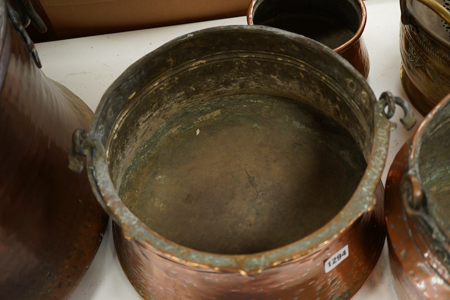 A collection of four copper vessels and another brass, largest 32cm